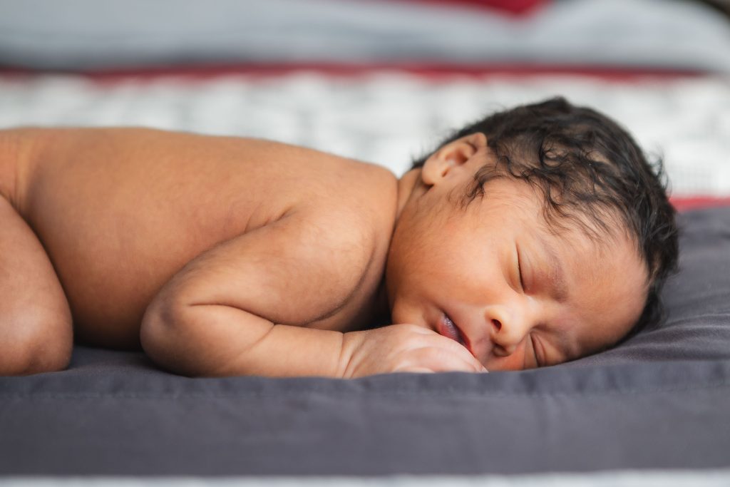 A peaceful newborn resting soundly in a warm family home.