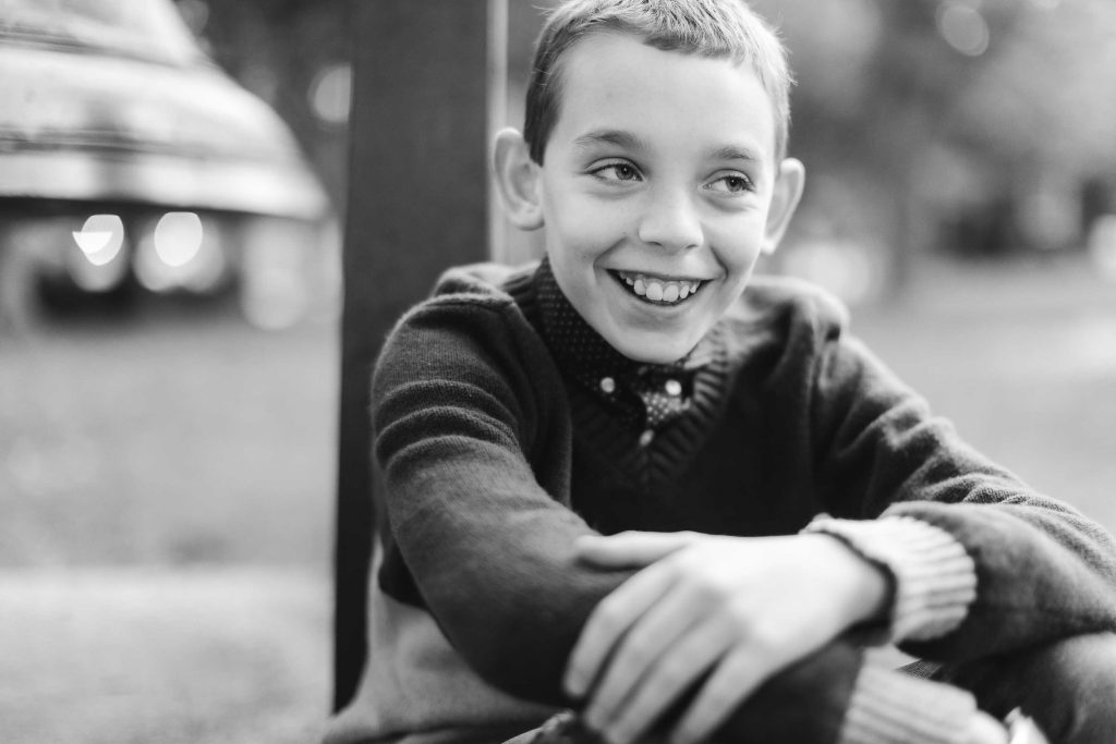 A black and white photo of a boy sitting on a bench in Downtown Annapolis.