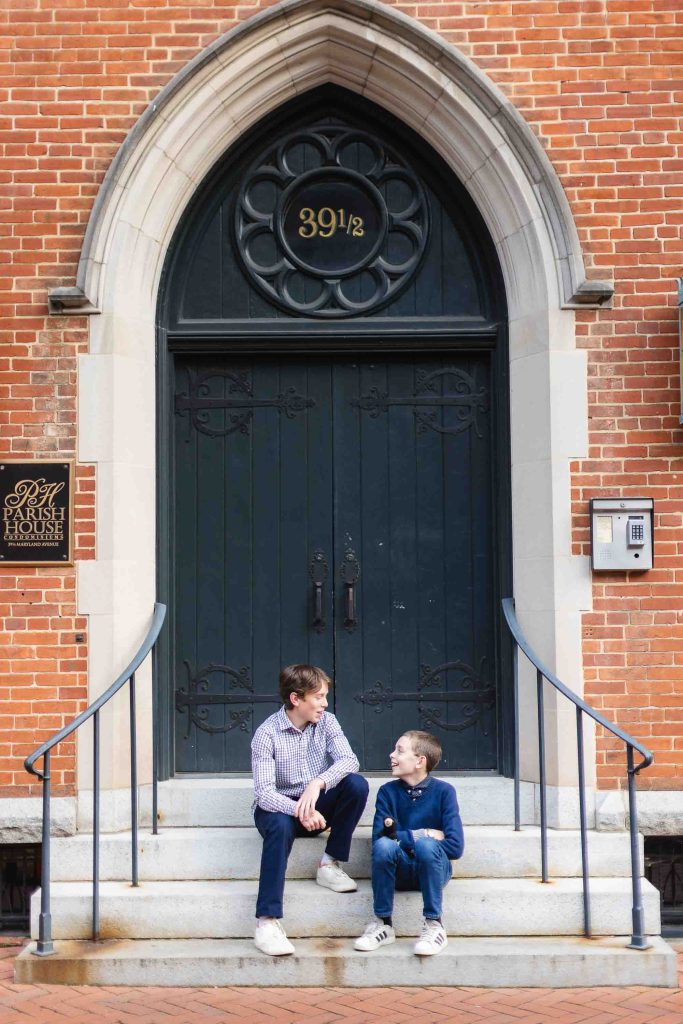 Two men sitting on the steps of a downtown Annapolis building.