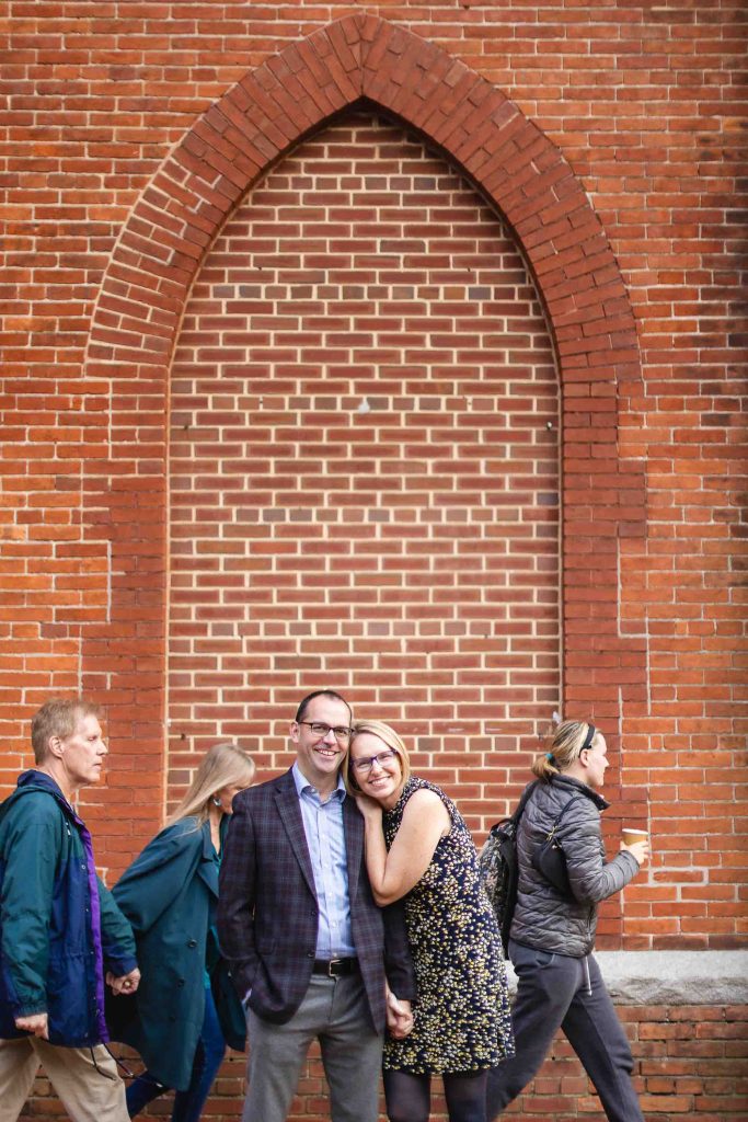 A family posing in front of a brick building in Downtown Annapolis.