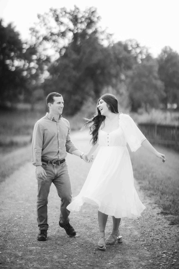 An engaged couple walking down a path during sunset in Maryland.