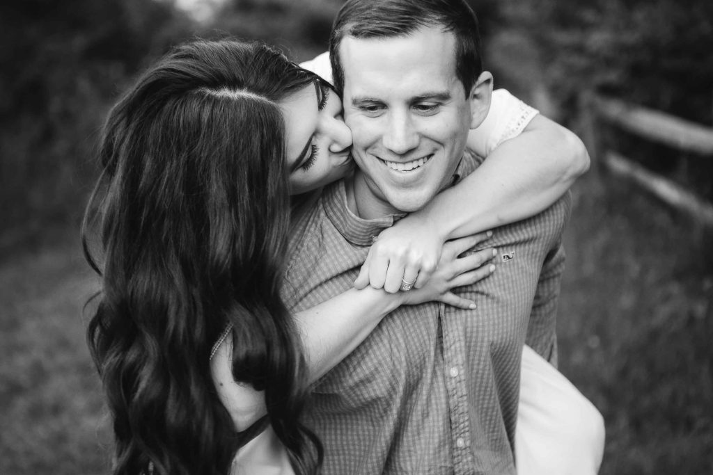 A black and white photo of a man hugging a woman in Patuxent Research Refuge, Maryland.