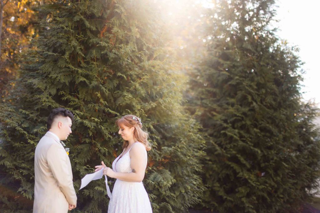 A wedding couple having their First Look moment in front of trees at Blackwall Barn & Lodge.