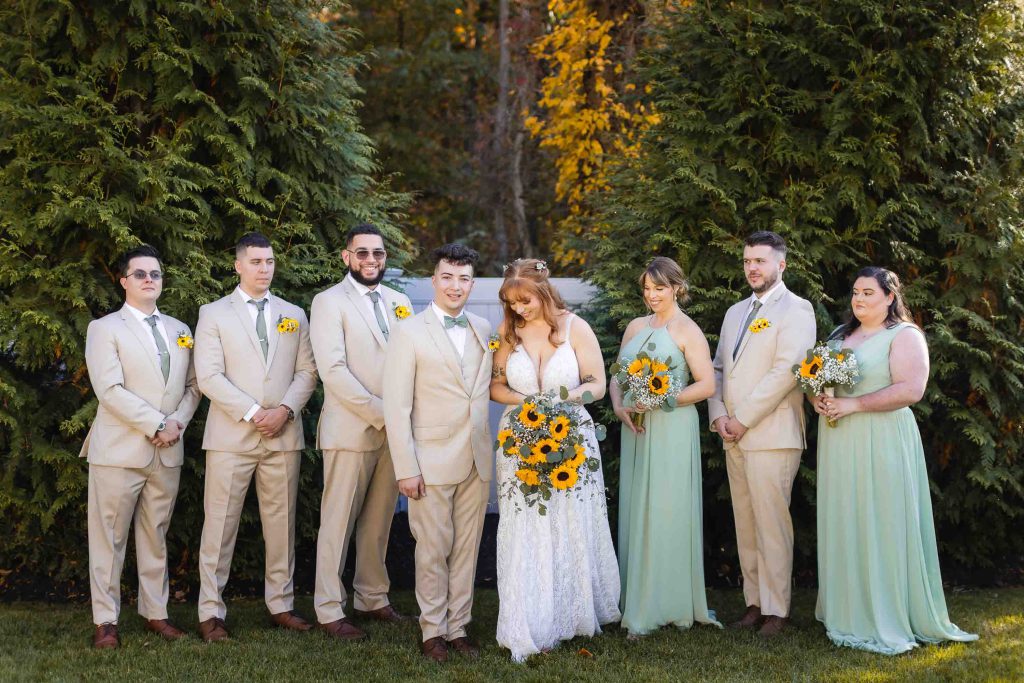 A group of bridesmaids and groomsmen posing for a wedding portrait at Blackwall Barn & Lodge.