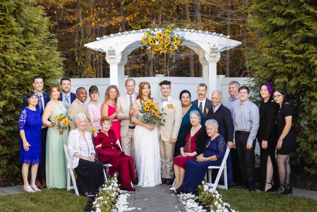 A group of people posing for a wedding photo at Blackwall Barn & Lodge.