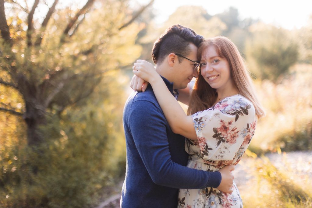 A couple embraces in the woods during their engagement session at Patuxent Research Refuge.