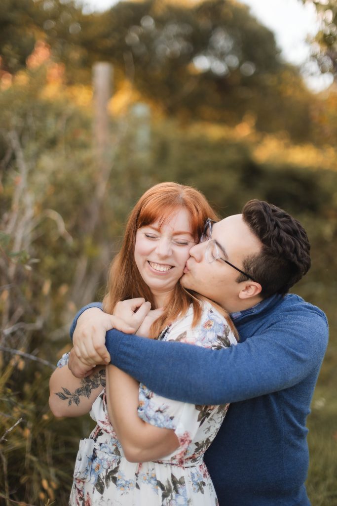 A couple hugging in Patuxent Research Refuge during their engagement session.