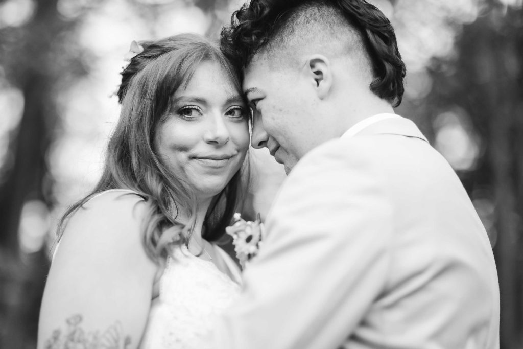 A black and white wedding portrait of a bride and groom hugging at the Blackwall Barn & Lodge.