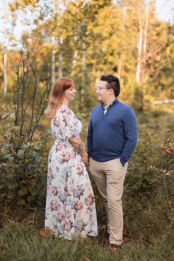 An engaged couple standing in the Patuxent Research Refuge during their engagement session.