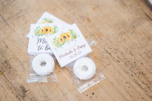 Sunflower wedding details on a wooden table.