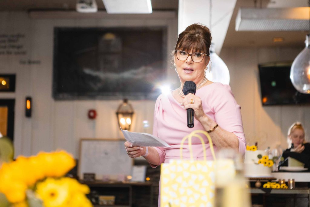 A woman speaking into a microphone at a wedding reception at Blackwall Barn & Lodge.