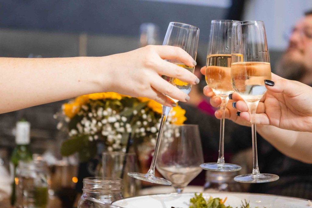 Guests toasting at a wedding reception at Blackwall Barn & Lodge.