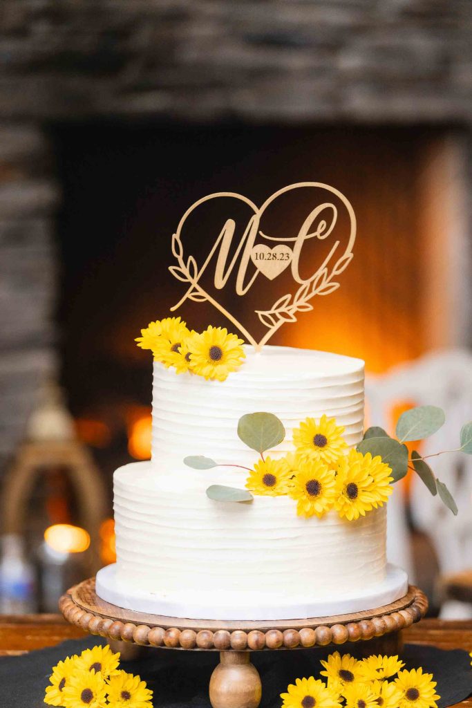 A detailed wedding cake topper featuring wooden sunflowers.