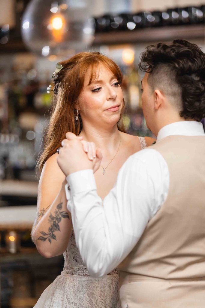At the Blackwall Barn & Lodge wedding reception, the bride and groom delightfully share their first dance.