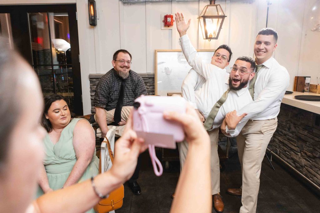 Wedding guests at Blackwall Barn & Lodge reception, capturing group photos.