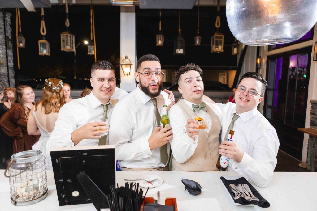 A group of men posing for a photo at a wedding reception at Blackwall Barn & Lodge.