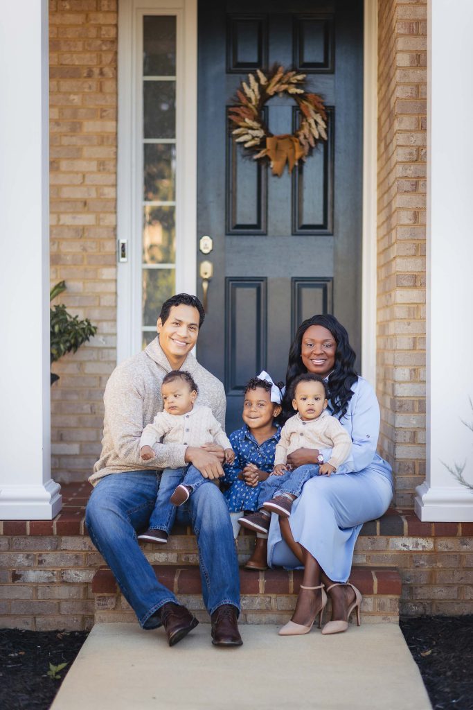 A family poses for intimate portraits at home.