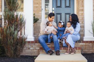 A family poses for portraits at home.