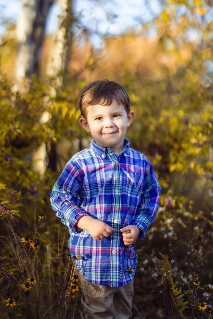 A young boy in a plaid shirt standing at Quiet Waters Park in Annapolis Maryland.
