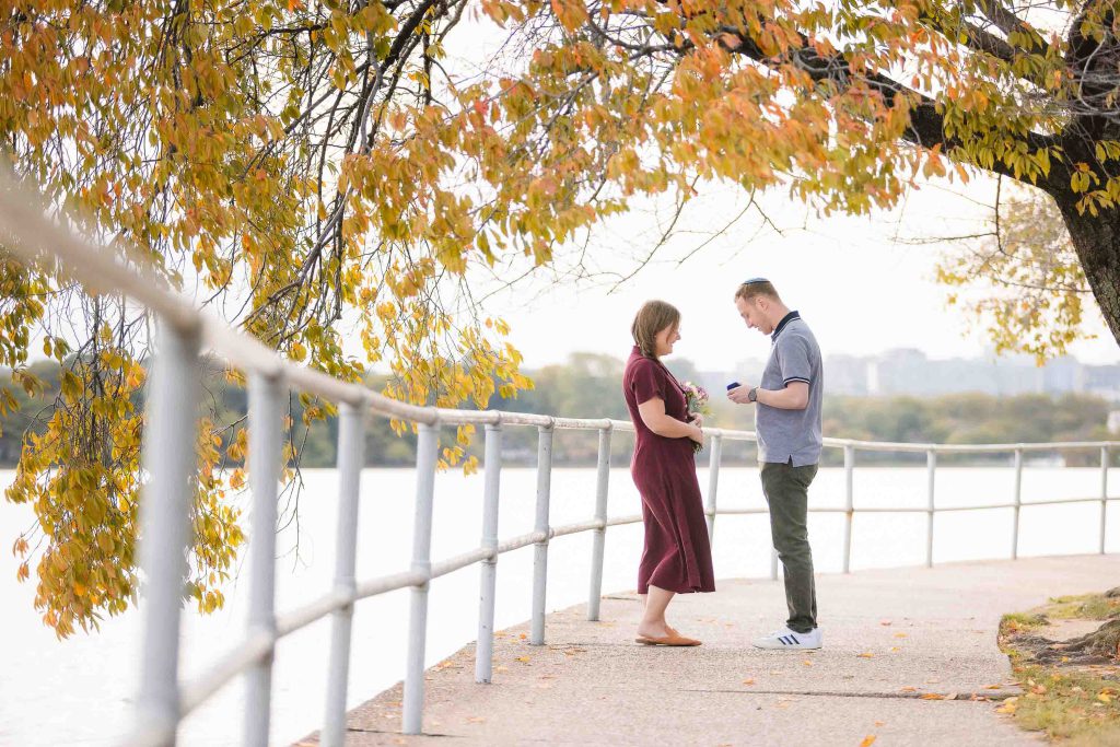 A couple standing near a river in Washington DC, at Tidal Basin.