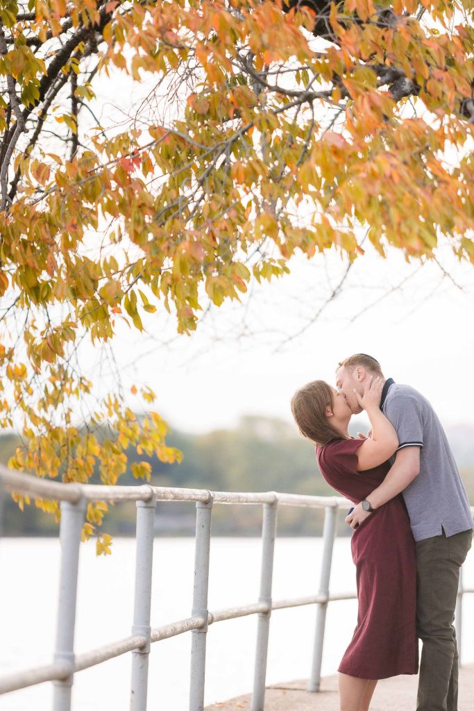 A couple kissing on a bridge in Washington DC.