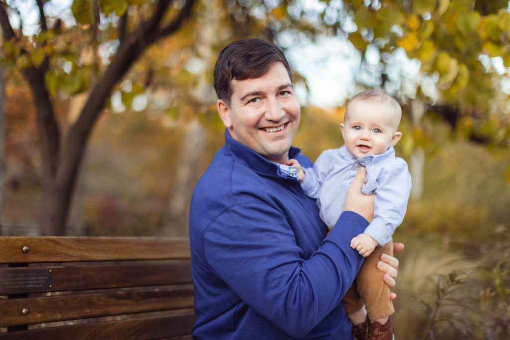 A man holding a baby at Quiet Waters Park in Annapolis, Maryland.