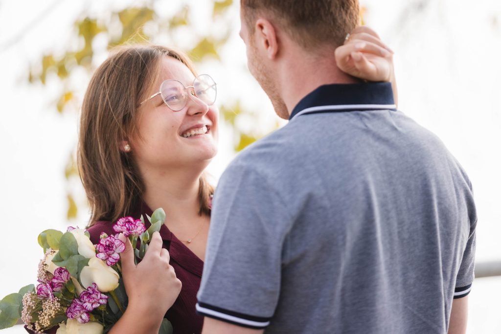 Keywords: Wedding Proposal

A man is holding flowers and smiling at a woman, as he surprises her with a wedding proposal.