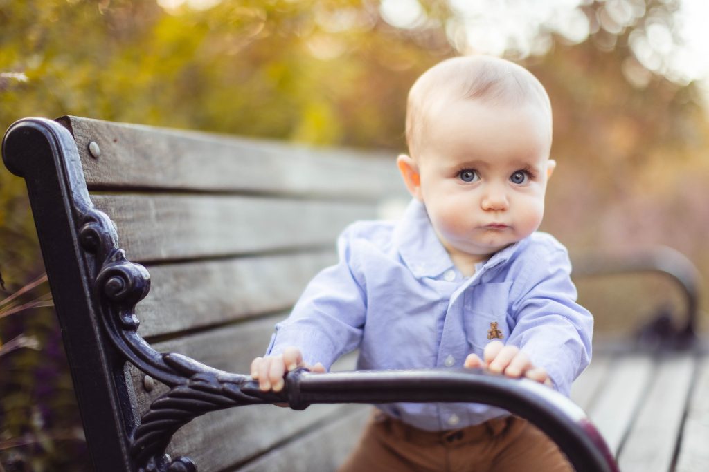 A baby sitting on a bench in Quiet Waters Park, Annapolis Maryland.