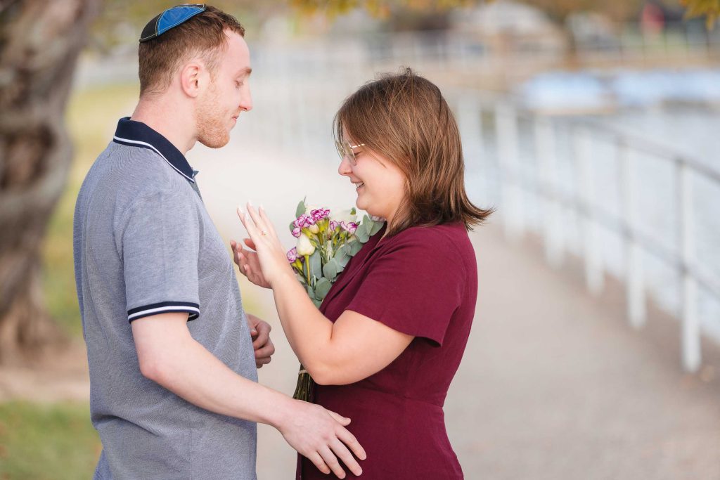 A man and woman standing next to each other holding flowers in Washington DC.