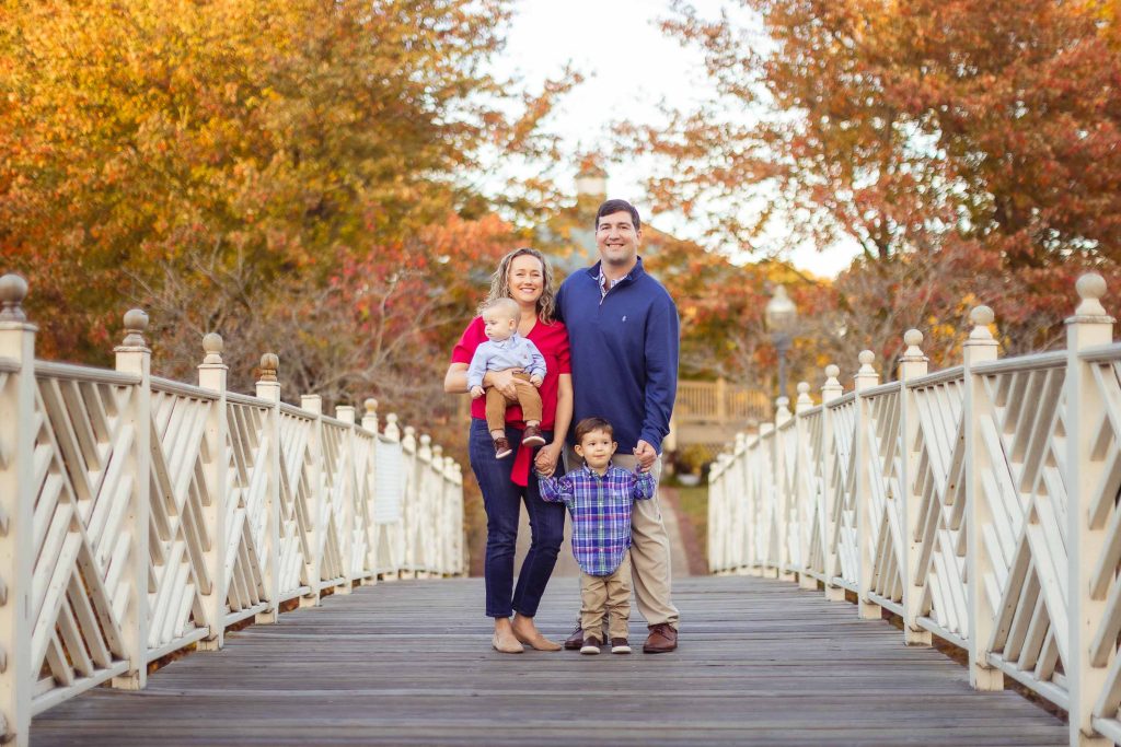 A Family posing on a wooden bridge at Quiet Waters Park in Annapolis, Maryland.