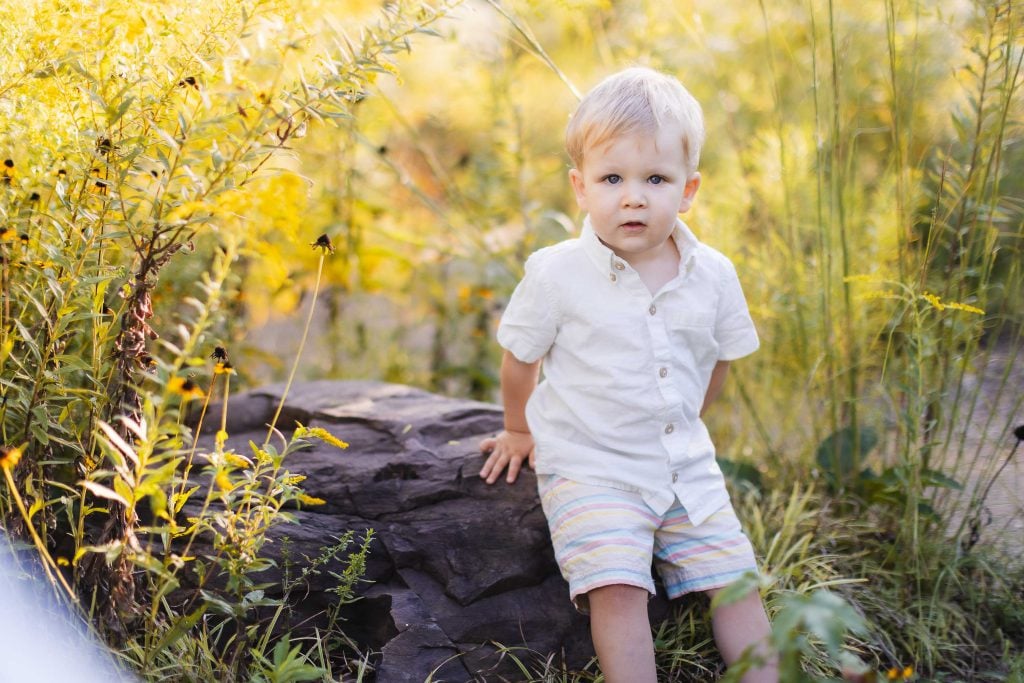 A young boy enjoying the peaceful scenery at Quiet Waters Park in Annapolis, surrounded by a field of tall grass.