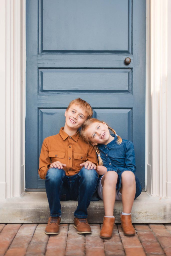 Two children sitting on the steps of Belair Mansion in Bowie Maryland.