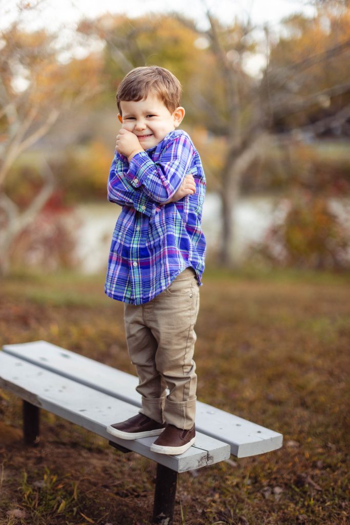 A young boy standing in Quiet Waters Park.