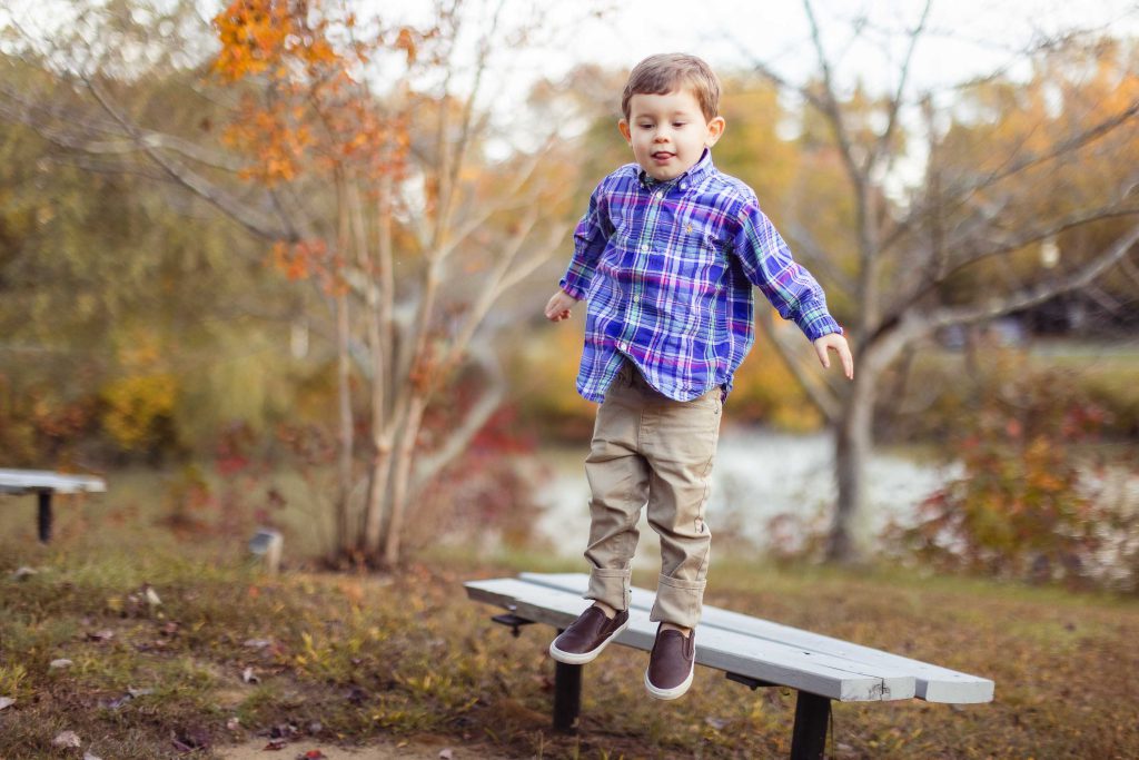 A young boy jumping on a bench in Quiet Waters Park, Annapolis Maryland.