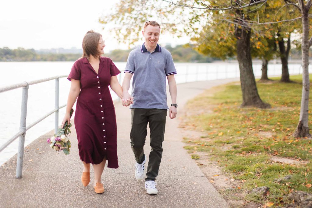 A couple walking along a walkway near the Tidal Basin in Washington DC.