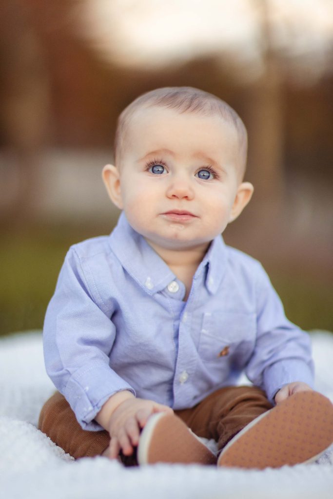 A baby boy in Annapolis, Maryland sitting on a blanket.