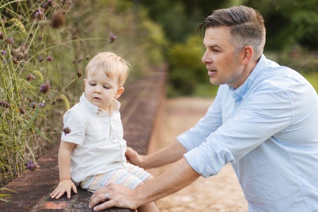 A man is holding a small boy in his arms for a family portrait in Annapolis.
